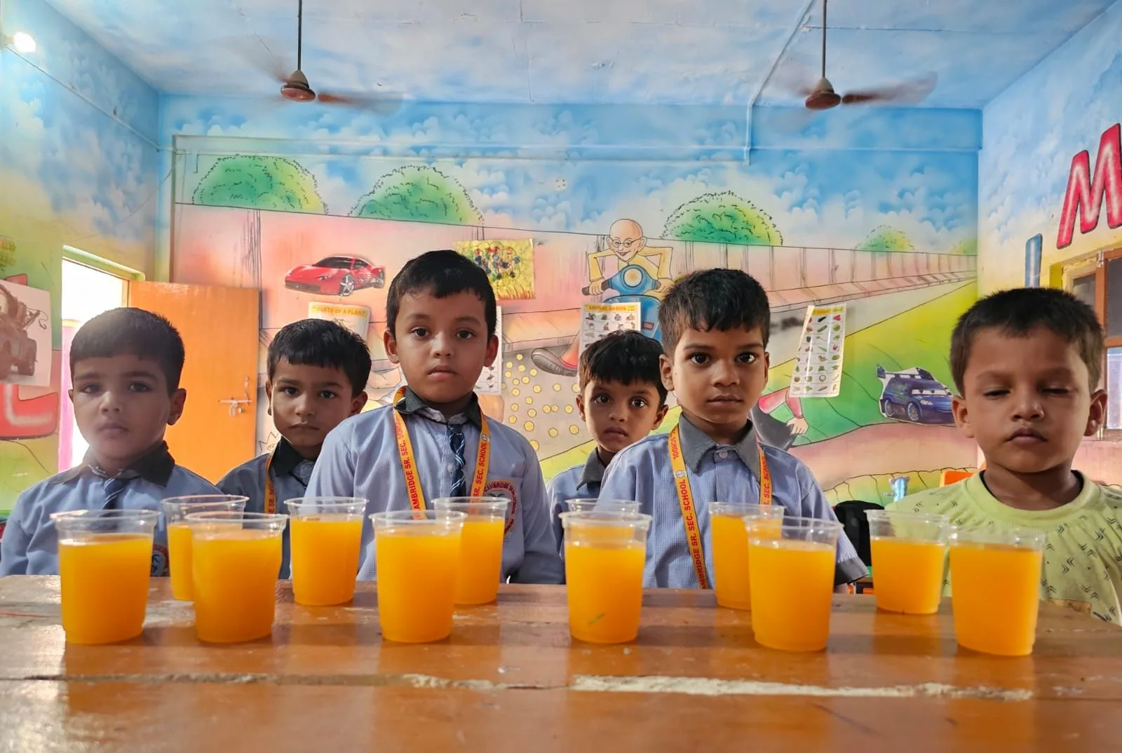 Pre-primary students with glasses of fresh juice
