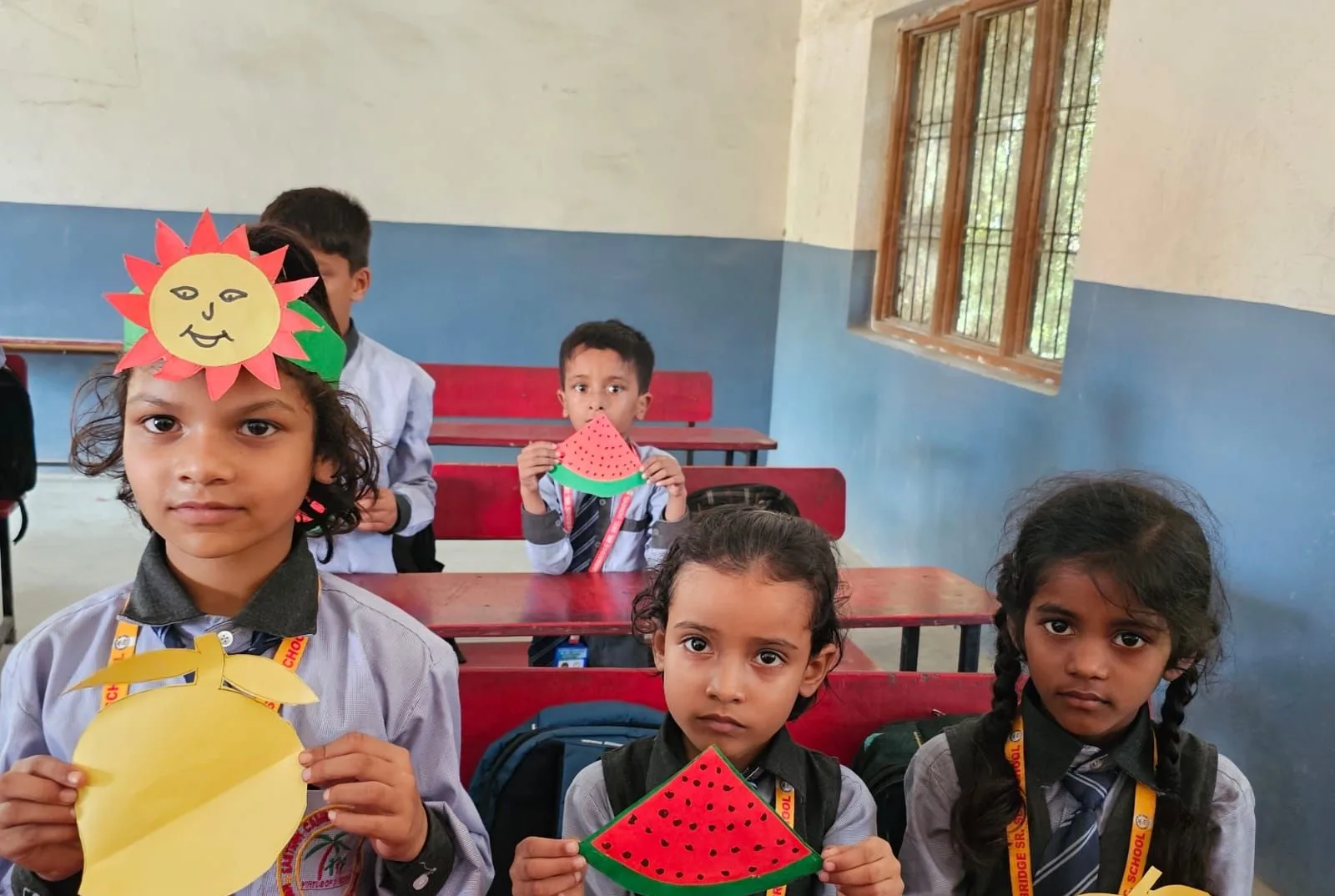 Young students with their paper fruit crafts